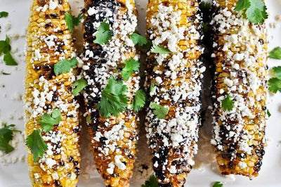 Grilled Corn with Bacon Butter and Cotija Cheese.